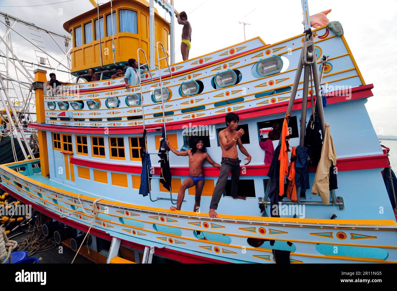 Thai fishermen on their fishing vessels in Ban Sapan, Gulf of Thailand. Stock Photo