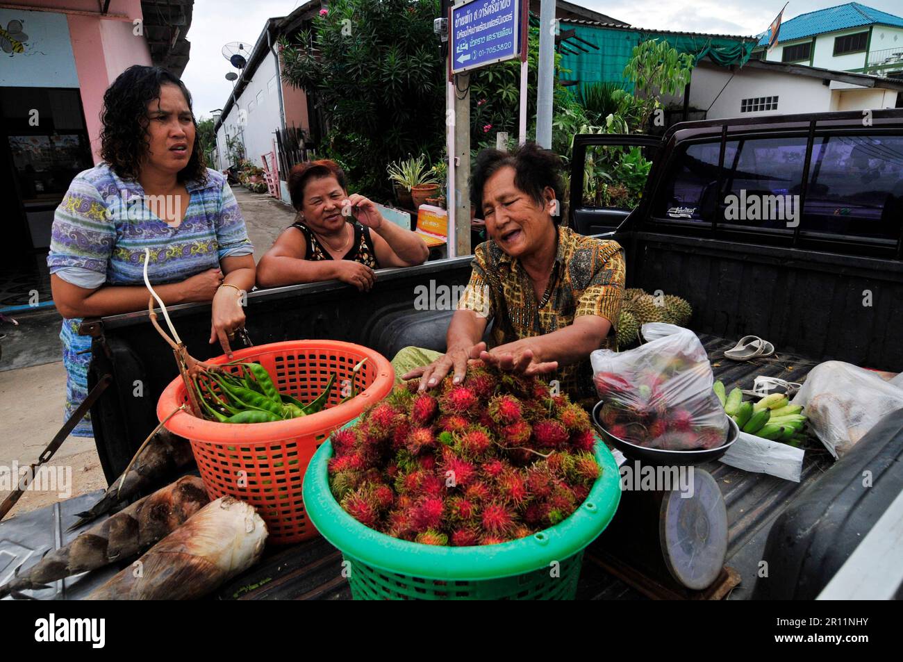Selling Rambutans from the back of a pickup truck in south Thailand. Stock Photo