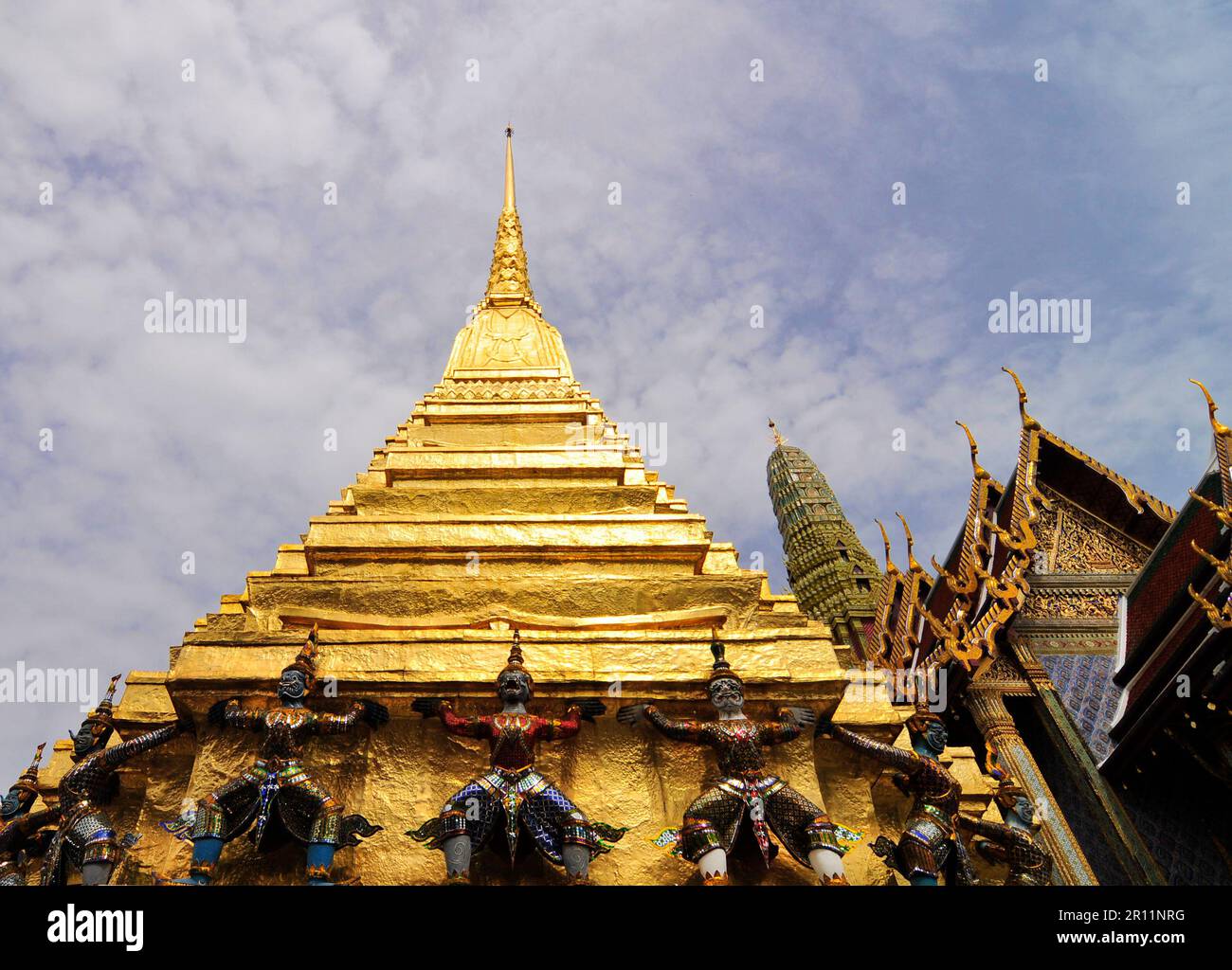 Mythical creatures supporting the golden pagoda at the Grand Palace in Bangkok, Thailand. Stock Photo