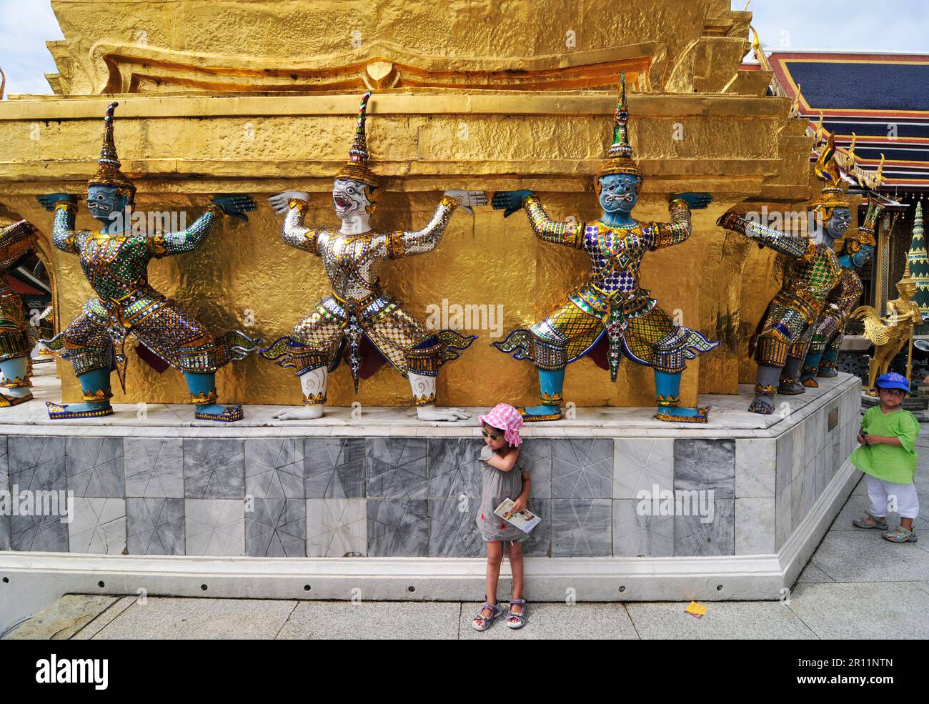 Mythical creatures supporting the golden pagoda at the Grand Palace in Bangkok, Thailand. Stock Photo