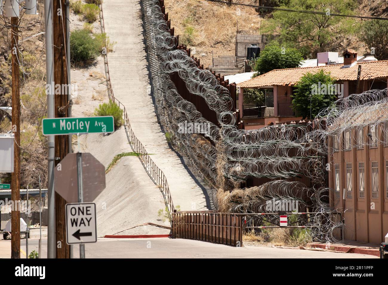 Daytime view of the fortified USA Mexico border wall as it runs through downtown Nogales