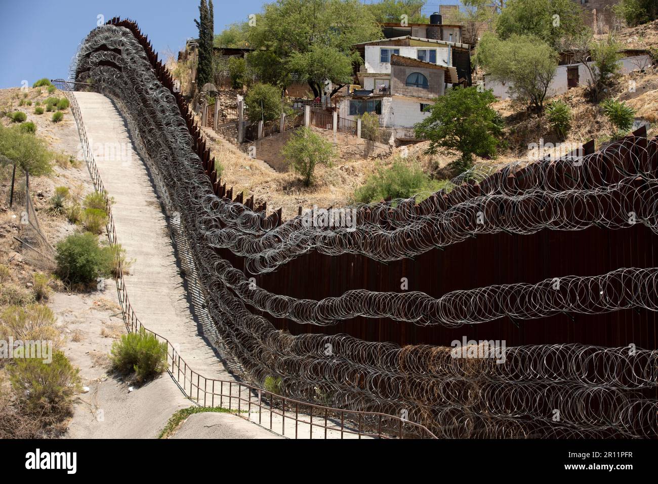Daytime view of the fortified USA Mexico border wall as it runs through downtown Nogales
