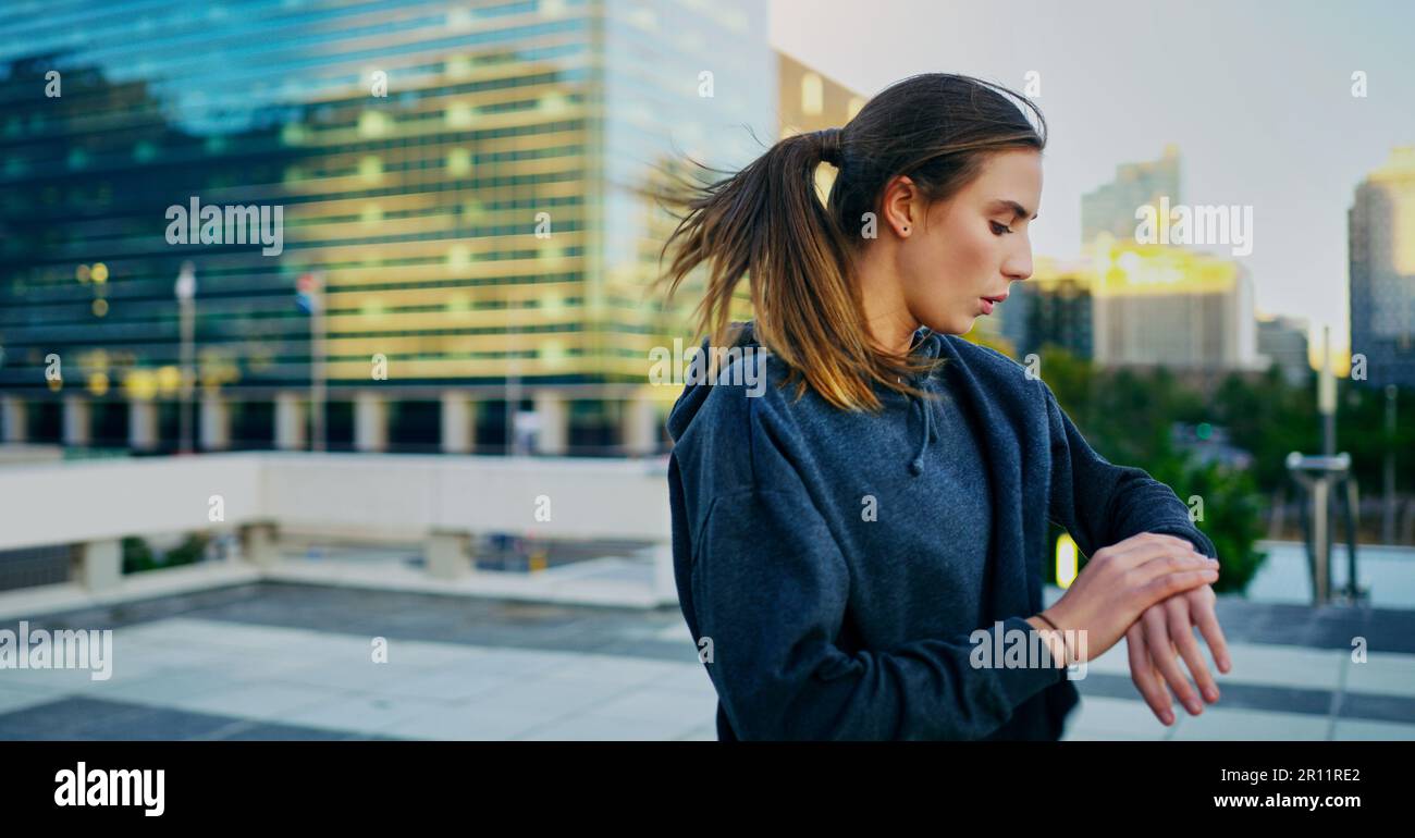 Keep pushing until you see progress. a young woman looking at her watch ...