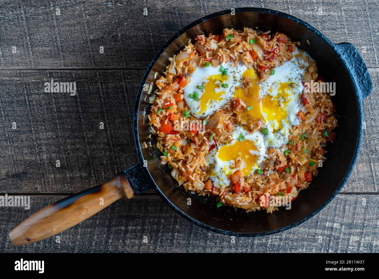 Ukraine Rice Boiled rice with fried eggs, red peppers, tomato and onions, close up ...
