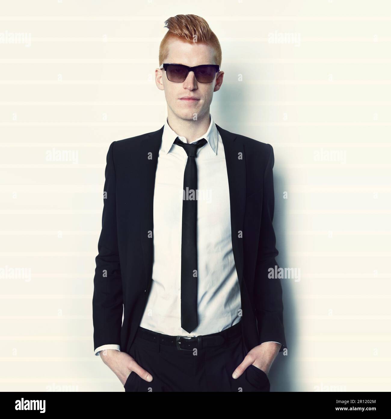 Fashion, suit and portrait of a man in a studio with sunglasses and a ...