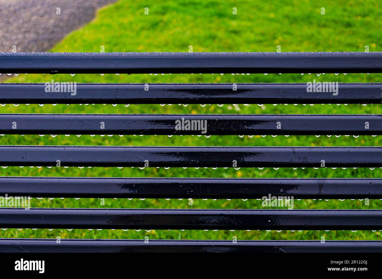 Close up of rain drops on a public bench at Seapark County Down Northern Ireland Stock Photo