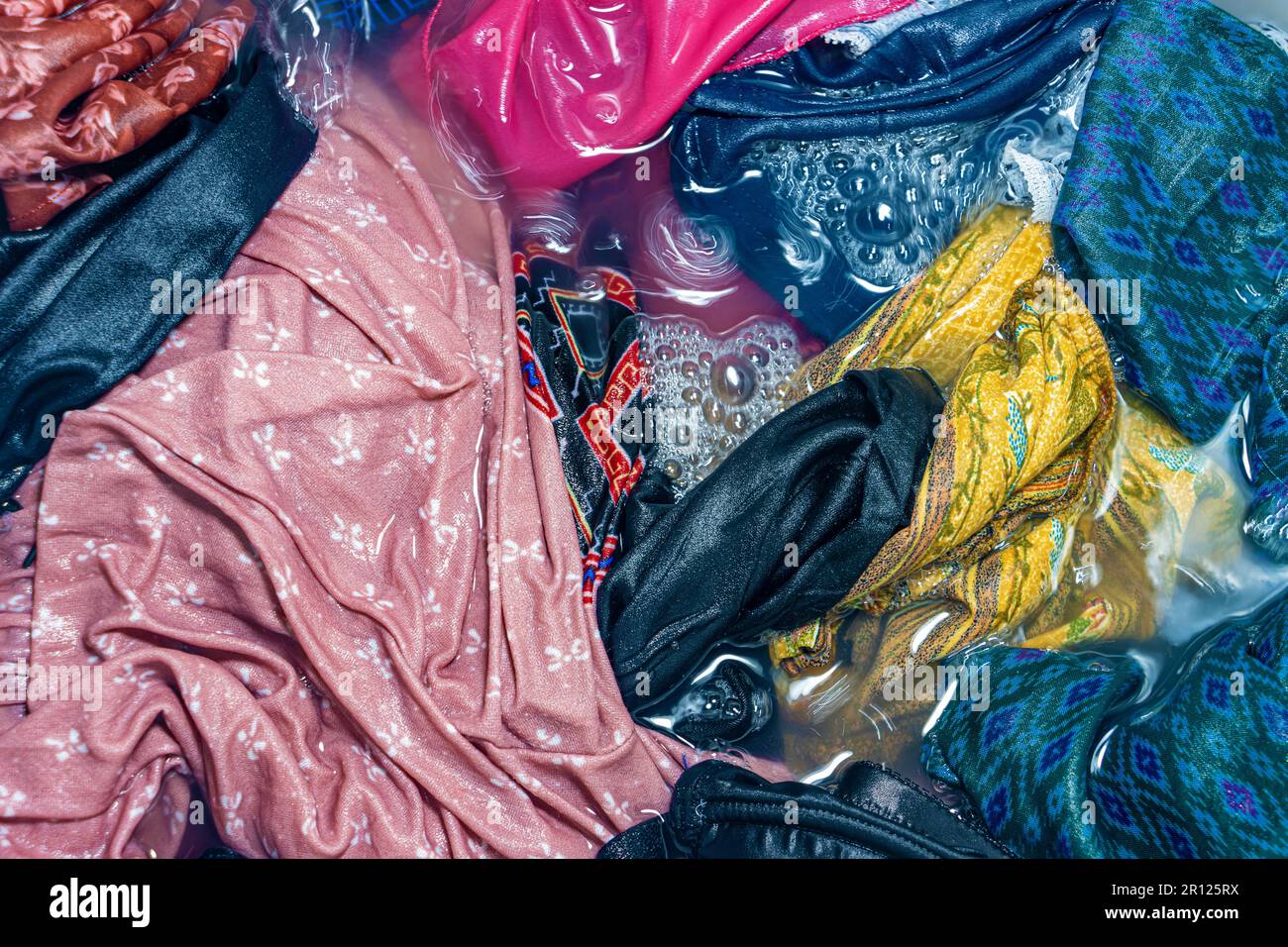 Laundry soaked in water is ready for washing procedure Stock Photo