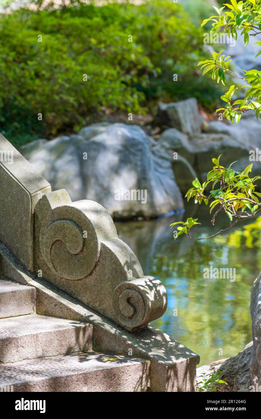 Detail stone carving beside a set of stairs at the Chinese Gardens of Friendship in Sydney, Australia Stock Photo