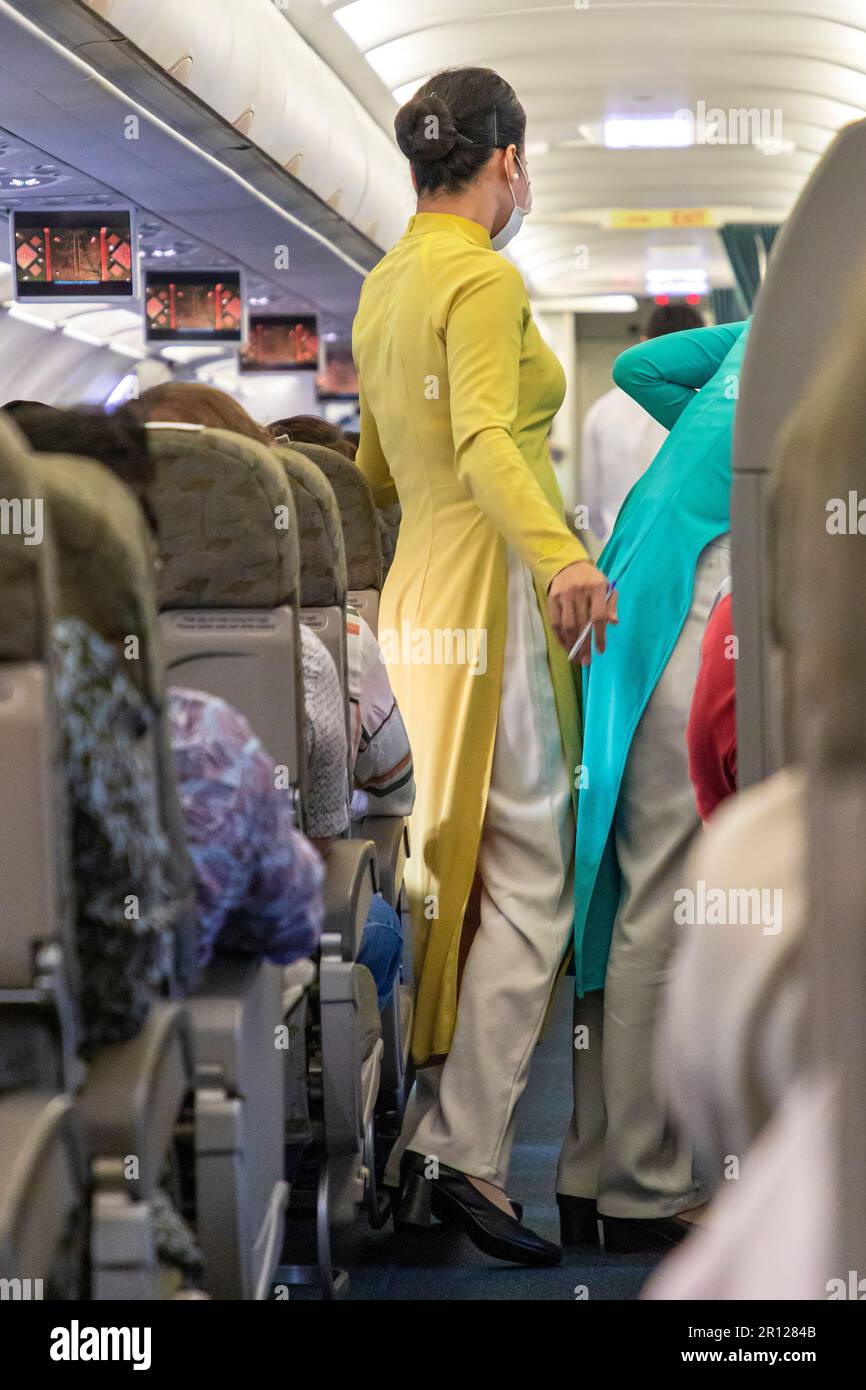 Vietnam Airlines cabin crew wearing traditional ao dai uniform on ...