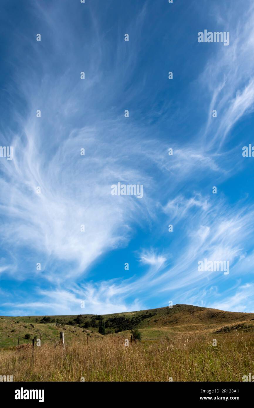 Swirling white cloud over hillside, near Hyde, Central Otago, South Island, New Zealand Stock Photo