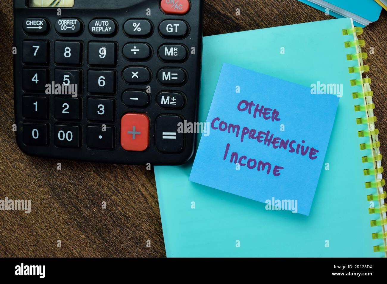 Concept of Other Comprehensive Income write on sticky notes isolated on Wooden Table. Stock Photo