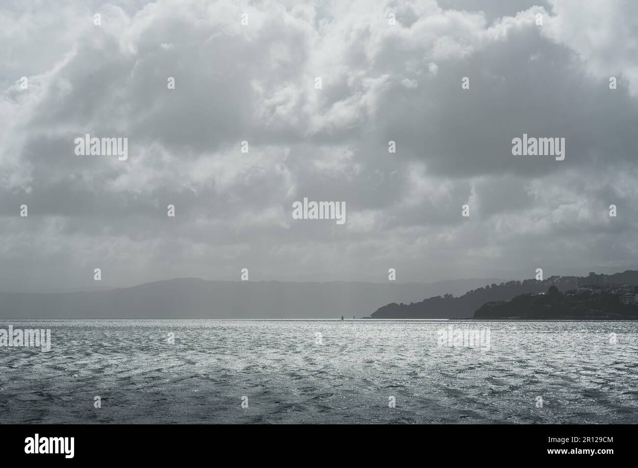 A bright, overcast sky with puffy white clouds floating in the air ...