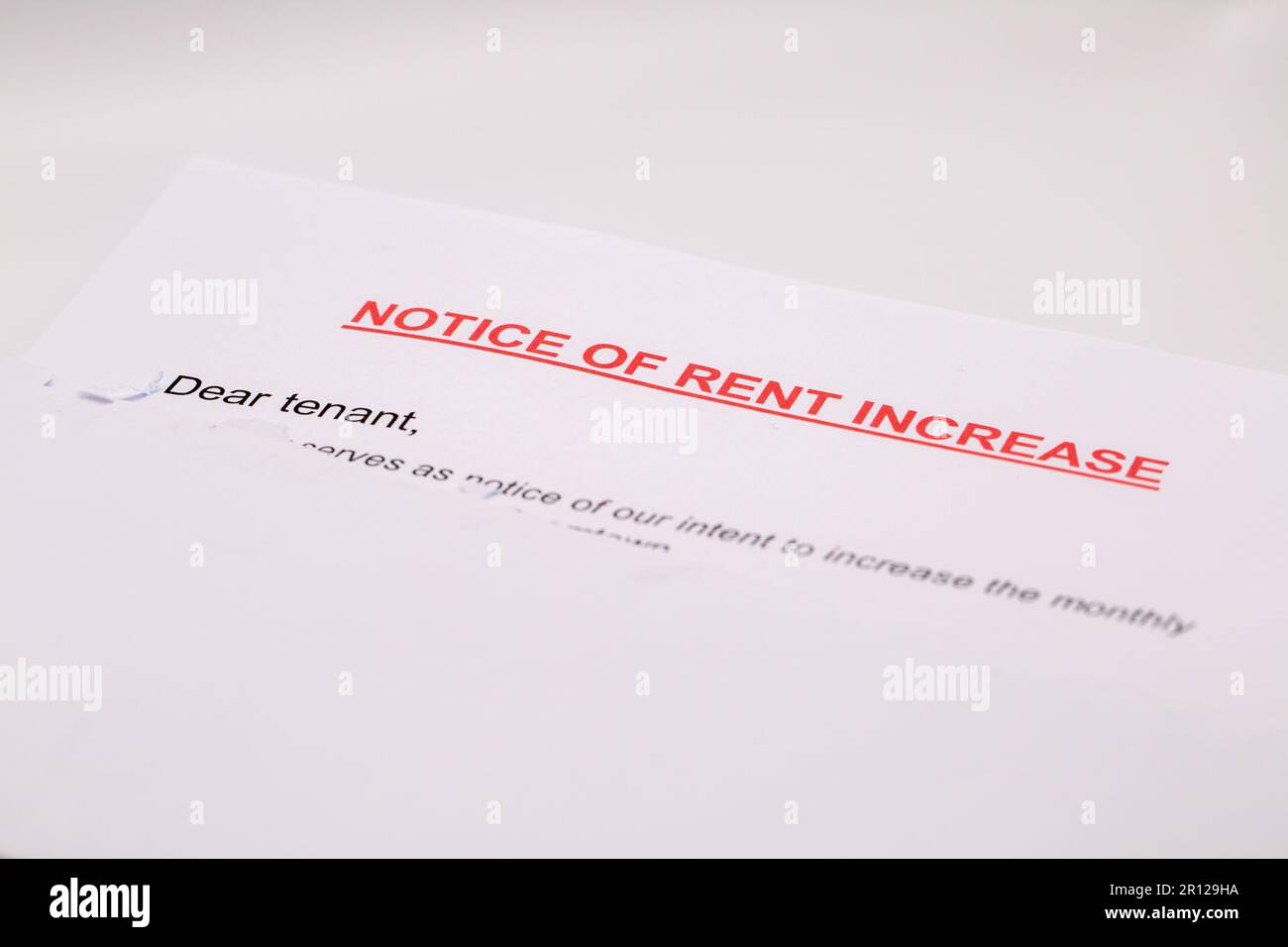 Rent increase typed notice (sticking out of white envelope) Stock Photo
