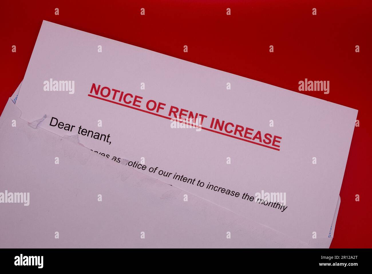 Rent increase typed notice (sticking out of white envelope Stock Photo