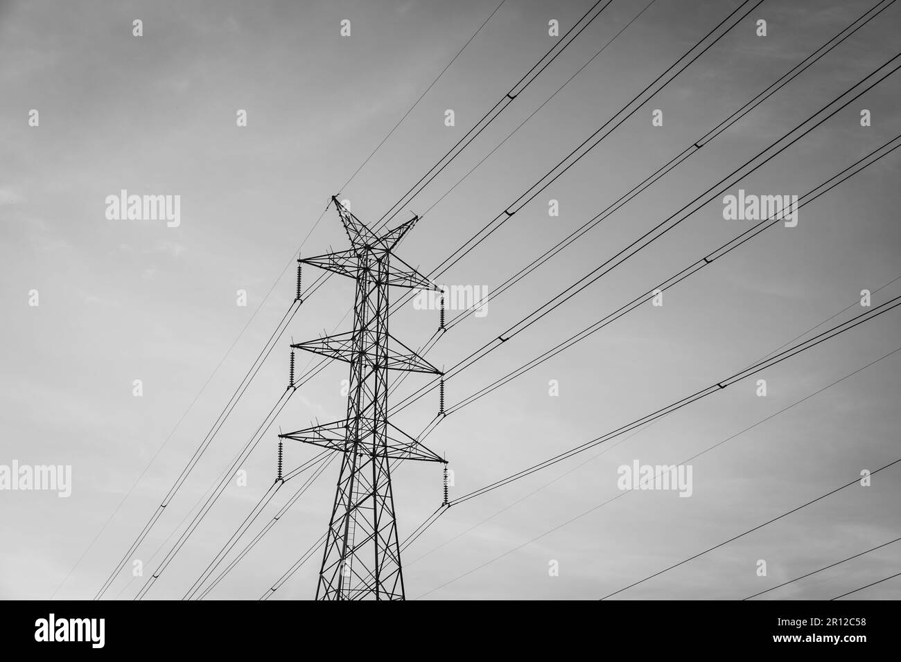High voltage post tower with blue sky before sunset background. Stock Photo