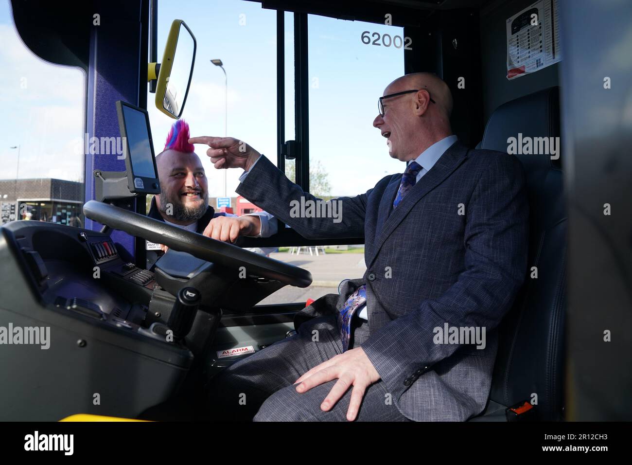 Minister for Transport Kevin Stewart (right) and Stuart Doidge with one of the new buses on show at the Traffic Scotland National Control Centre in South Queensferry, during the launch of the UK's first autonomous bus service. A fleet of five Alexander Dennis Enviro200AV vehicles will cover a 14-mile route, in mixed traffic, at up to 50mph across the Forth Road Bridge near Edinburgh. Picture date: Thursday May 11, 2023. Stock Photo