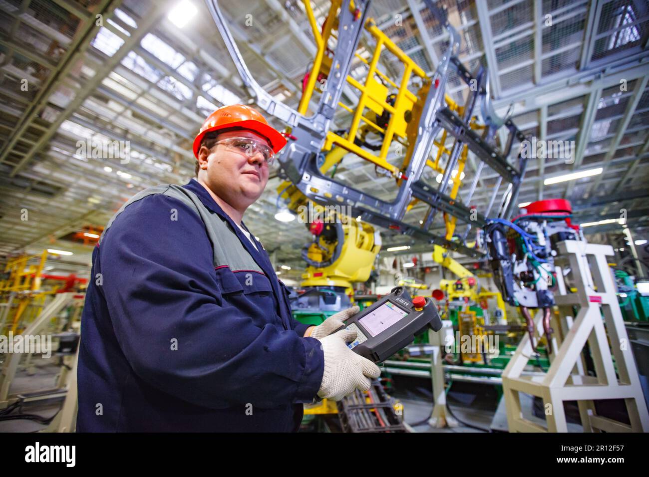 Nizhny Novgorod, Russia - November 21, 2020: GAZ car production plant. Operator adjust automatic welding line. Stock Photo