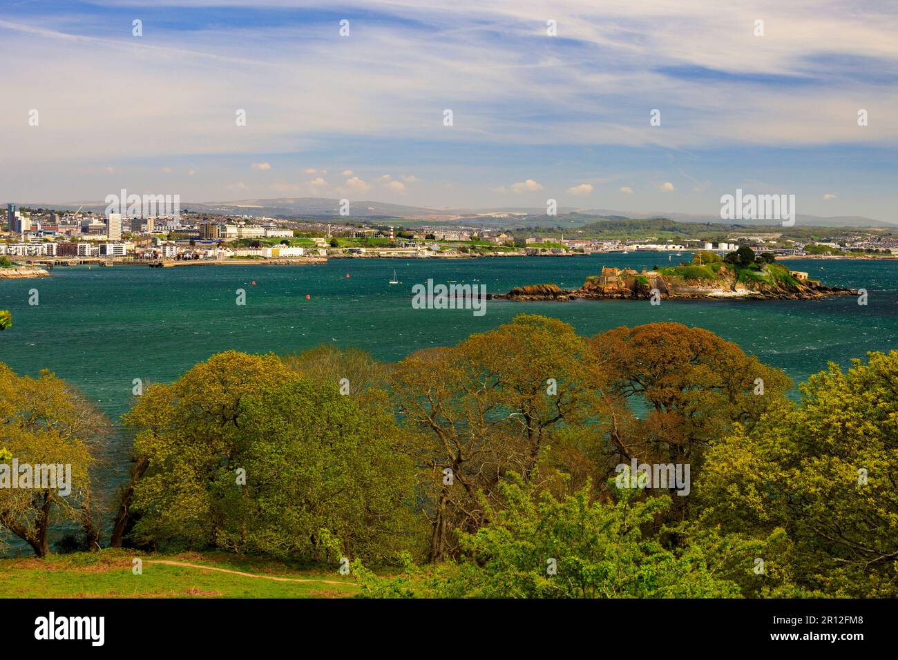 Looking across the River Tamar towards the Plymouth waterfront and Drake's Island from the Mount Edgcumbe Country Park, Cornwall, England, UK Stock Photo