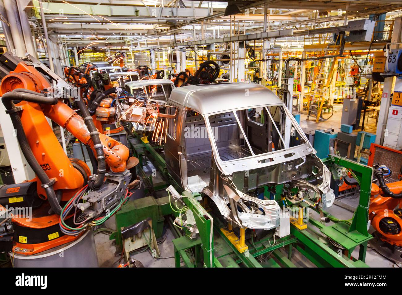 Nizhny Novgorod, Russia - November 21, 2020: GAZ car production plant. Automatic car bodies welding line. Kuka robot manipulators welds cabin Stock Photo