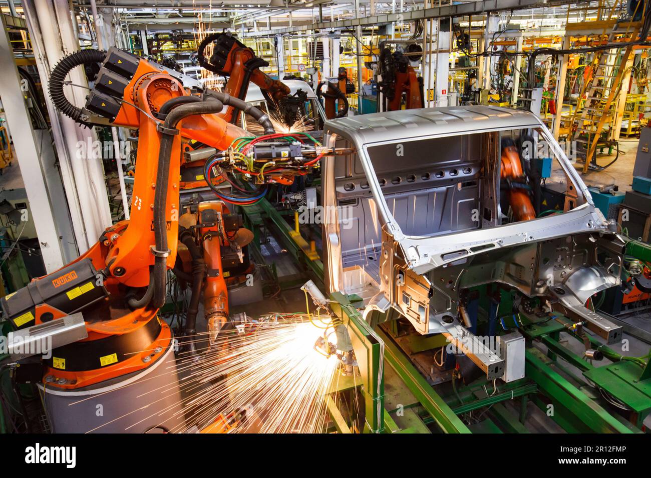 Nizhny Novgorod, Russia - November 21, 2020: GAZ car production plant. Automatic car bodies welding line. Kuka robot manipulators, welding sparks Stock Photo