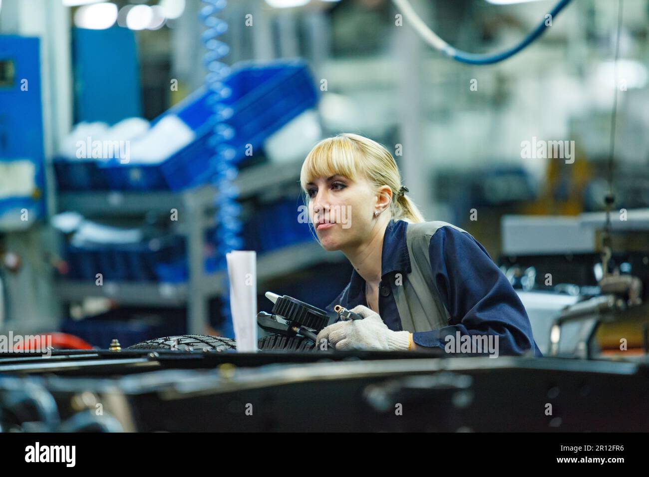 Nizhny Novgorod, Russia - November 21, 2020: GAZ car production plant. Young blonde woman worker. Stock Photo