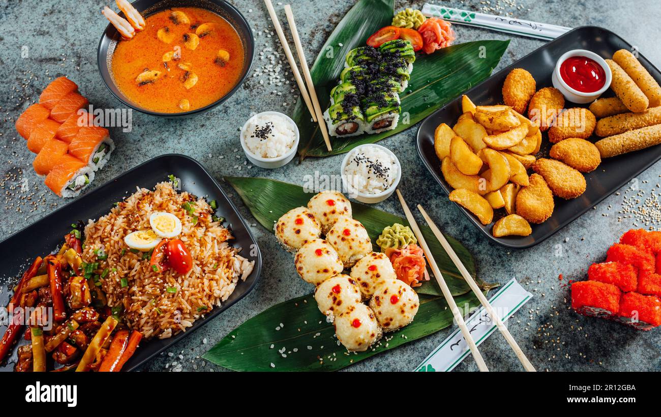 A variety of Asian and Thai dishes in metal trays, arranged in an