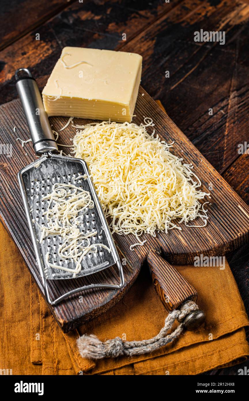 Italian hard cheese with grater on wooden background Stock Photo - Alamy