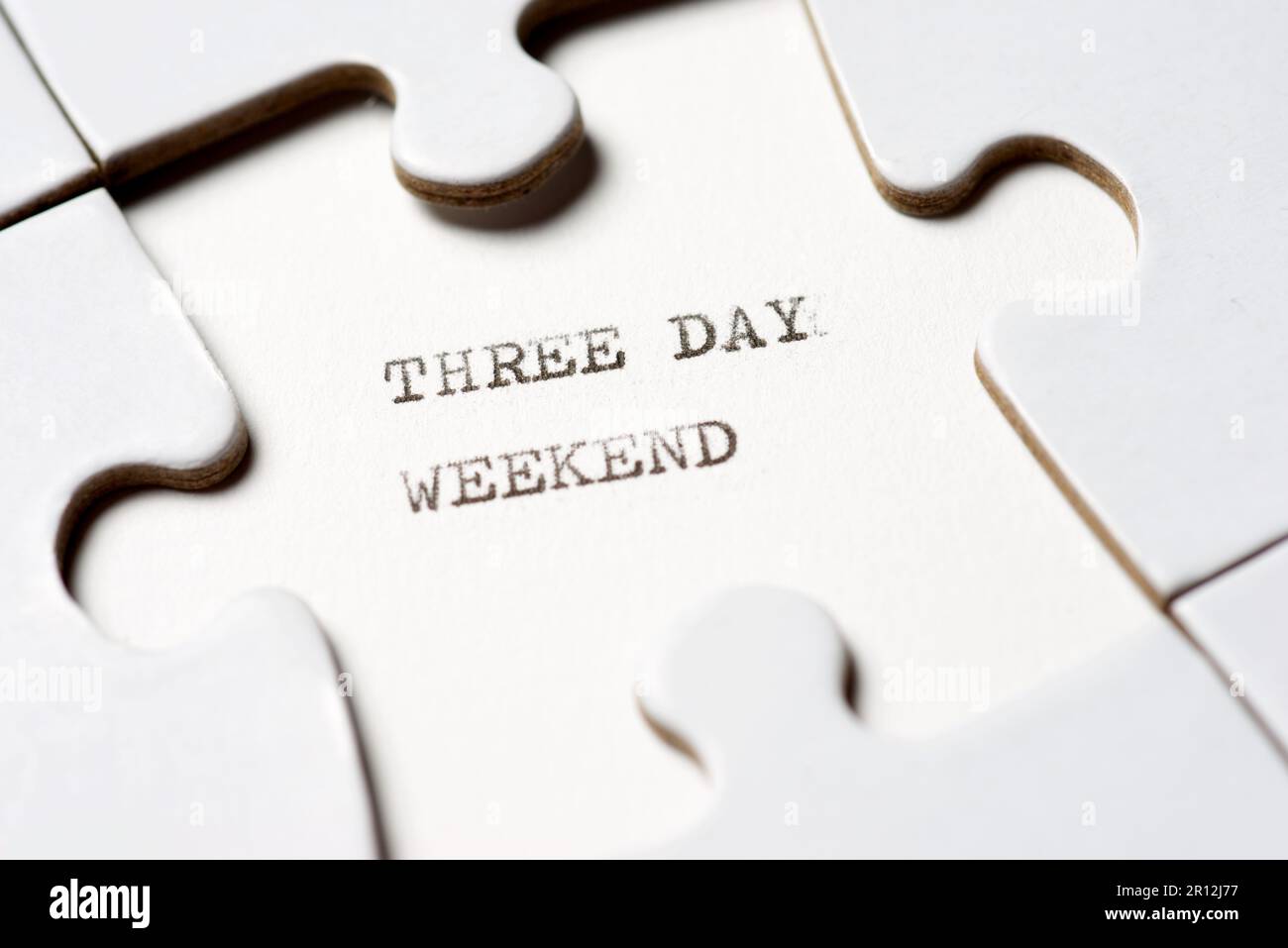Three day weekend text written with a typewriter in a white puzzle Stock Photo