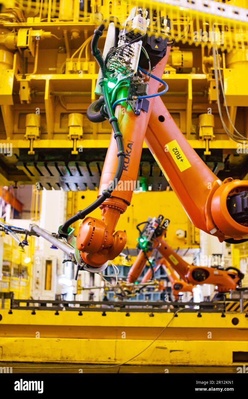 Nizhny Novgorod, Russia - November 21, 2020: GAZ car production plant. Kuka robot manipulators close-up photo. Stamping press on background Stock Photo