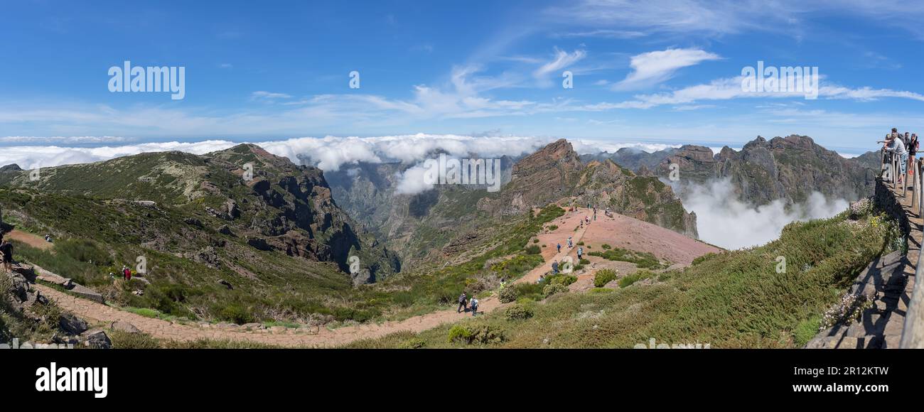 Madeira Island Portugal - 04 19 2023: Top at the mountains Pico do Areeiro and Pico Ruivo, people hiking on trails, low clouds and cinematic effect in Stock Photo