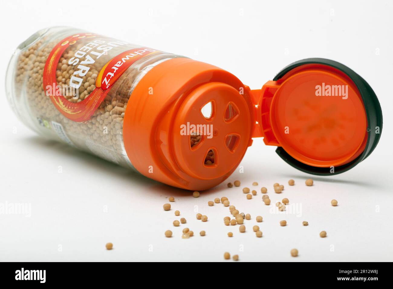 Jar of Schwartz Mustard Seeds Spilling out of container Stock Photo
