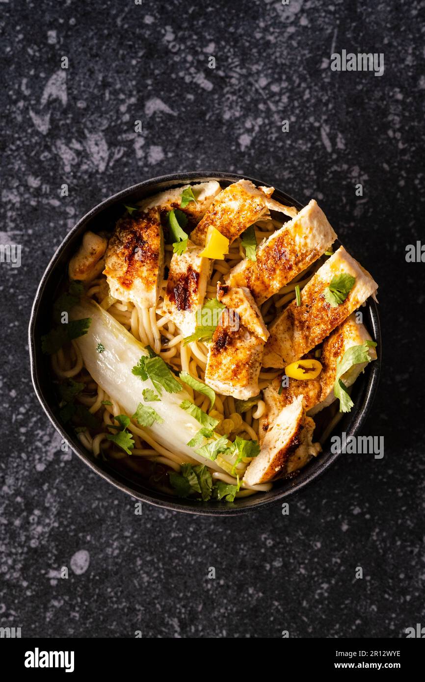 Grilled chicken with ginger, chinese greens and noodles Stock Photo Alamy