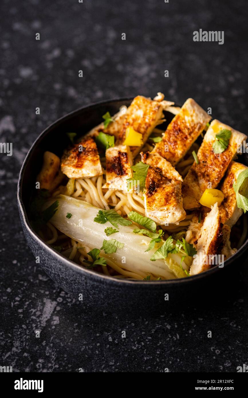 Grilled chicken with ginger, chinese greens and noodles Stock Photo Alamy