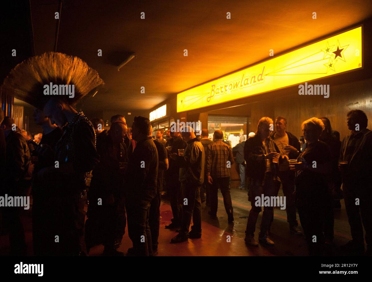 Punk rockers with a mohican queue at the bar at a gig at the Barrowlands Ballroom concert hall in Glasgow, Scotland Stock Photo