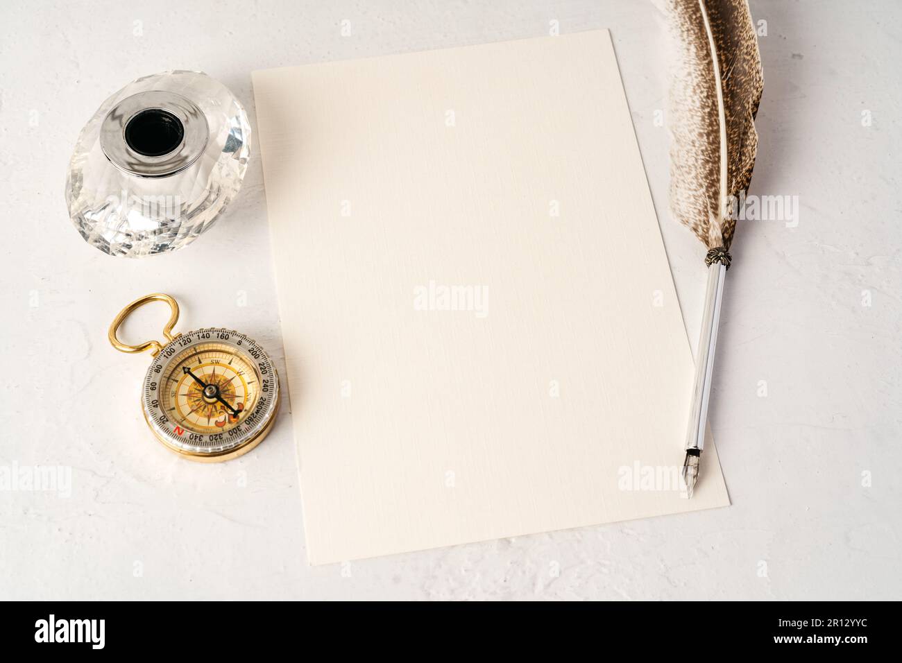 Old paper with compass and quill pen top view Stock Photo - Alamy