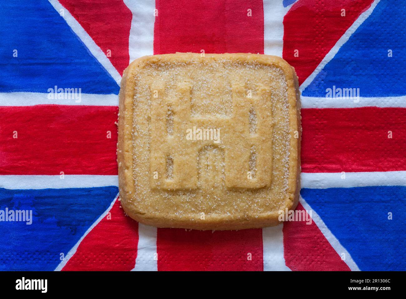 all butter shortbread biscuit to commemorate The Coronation of HM King Charles III 2023 from M&S on Union Jack napkin serviette Stock Photo