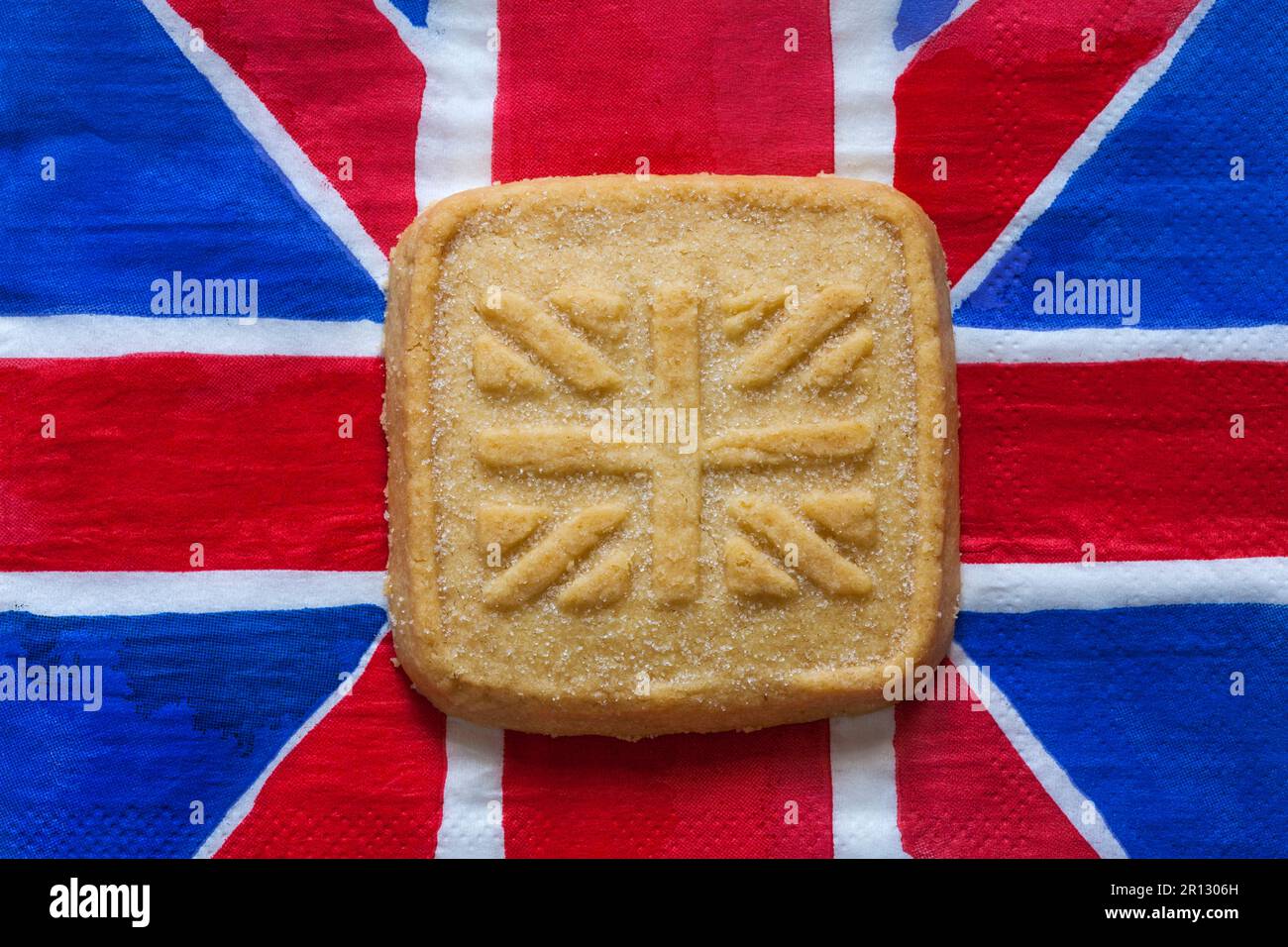 all butter shortbread biscuit to commemorate The Coronation of HM King Charles III 2023 from M&S on Union Jack napkin serviette Stock Photo