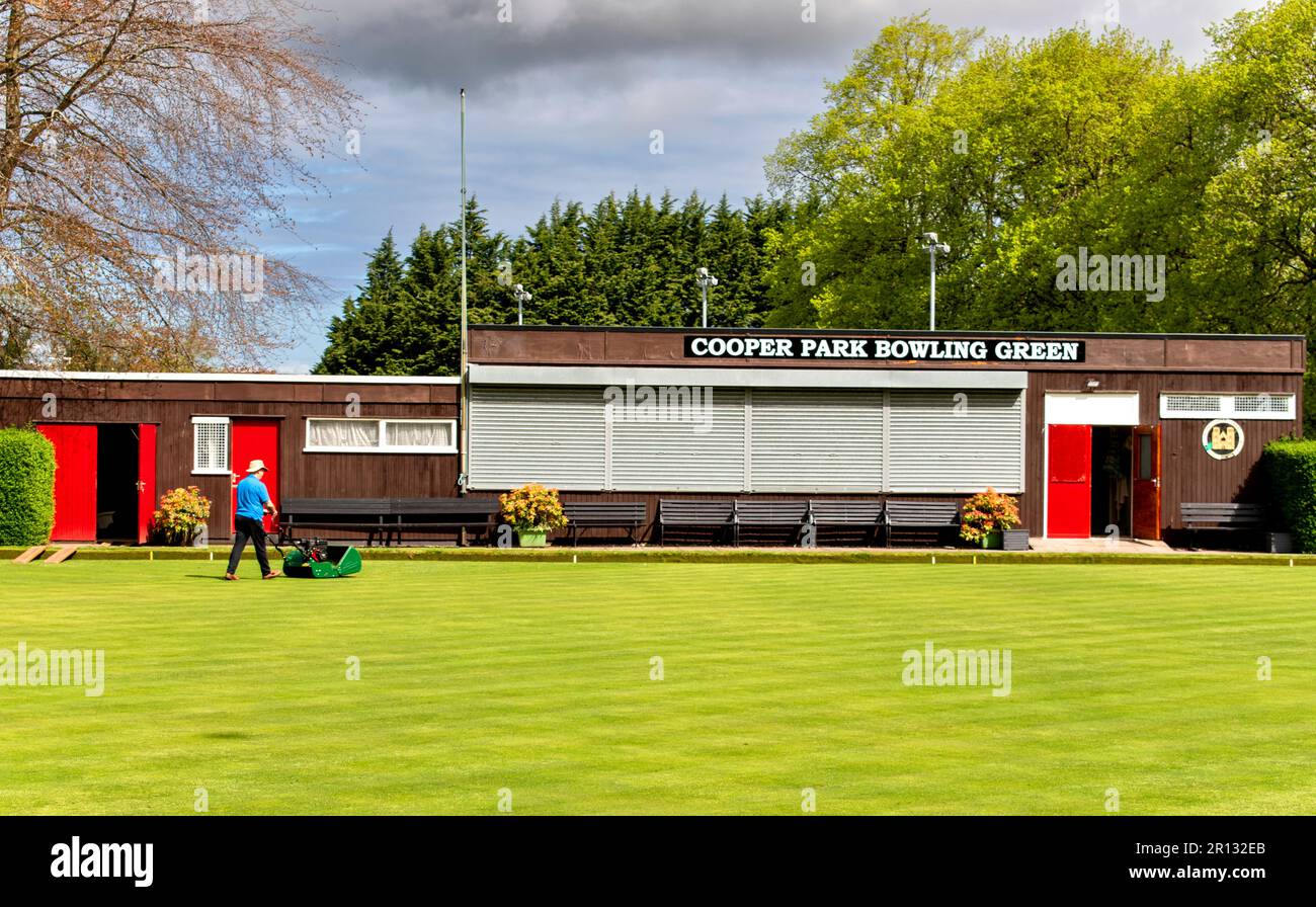 Elgin Town Moray Scotland Cooper Park the immaculate bowling green lawn and keeper with a lawn mower Stock Photo