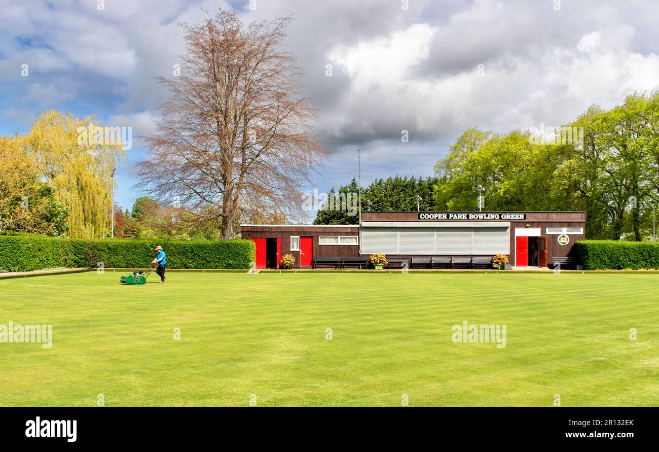 Elgin Town Moray Scotland Cooper Park the immaculate bowling green lawn and keeper with lawn mower Stock Photo
