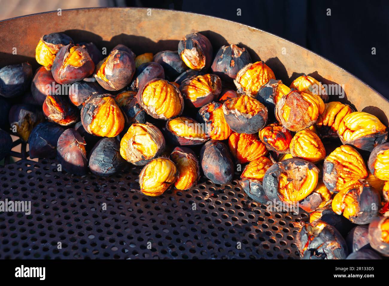 Roast Chestnuts on a Charcoal Grill . Street food delicious snack Stock