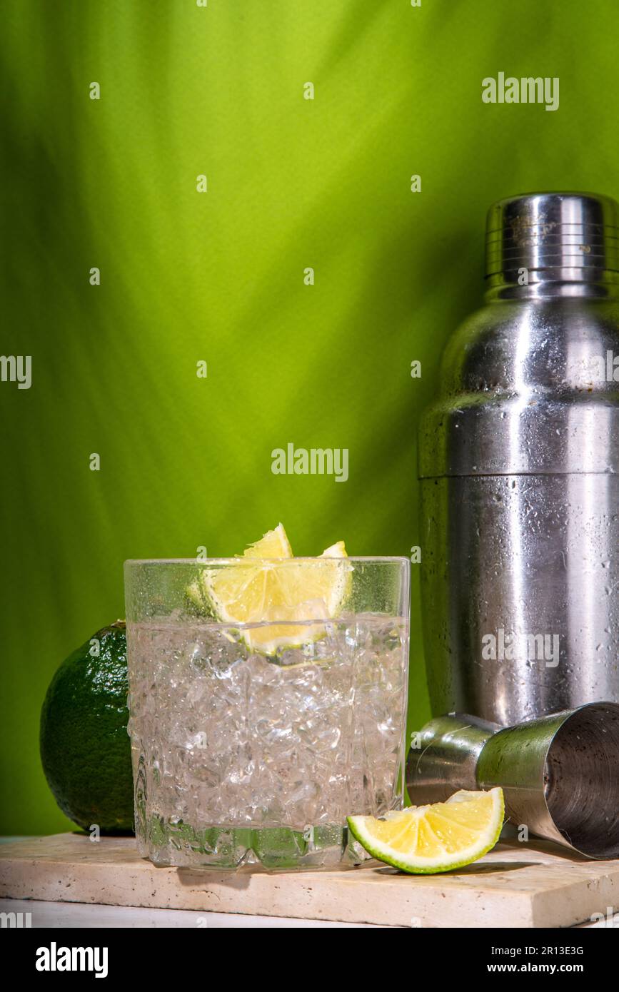 Cold iced Ti punch alcohol cocktail, small punch, rumbased mixed drink with fresh lime slice