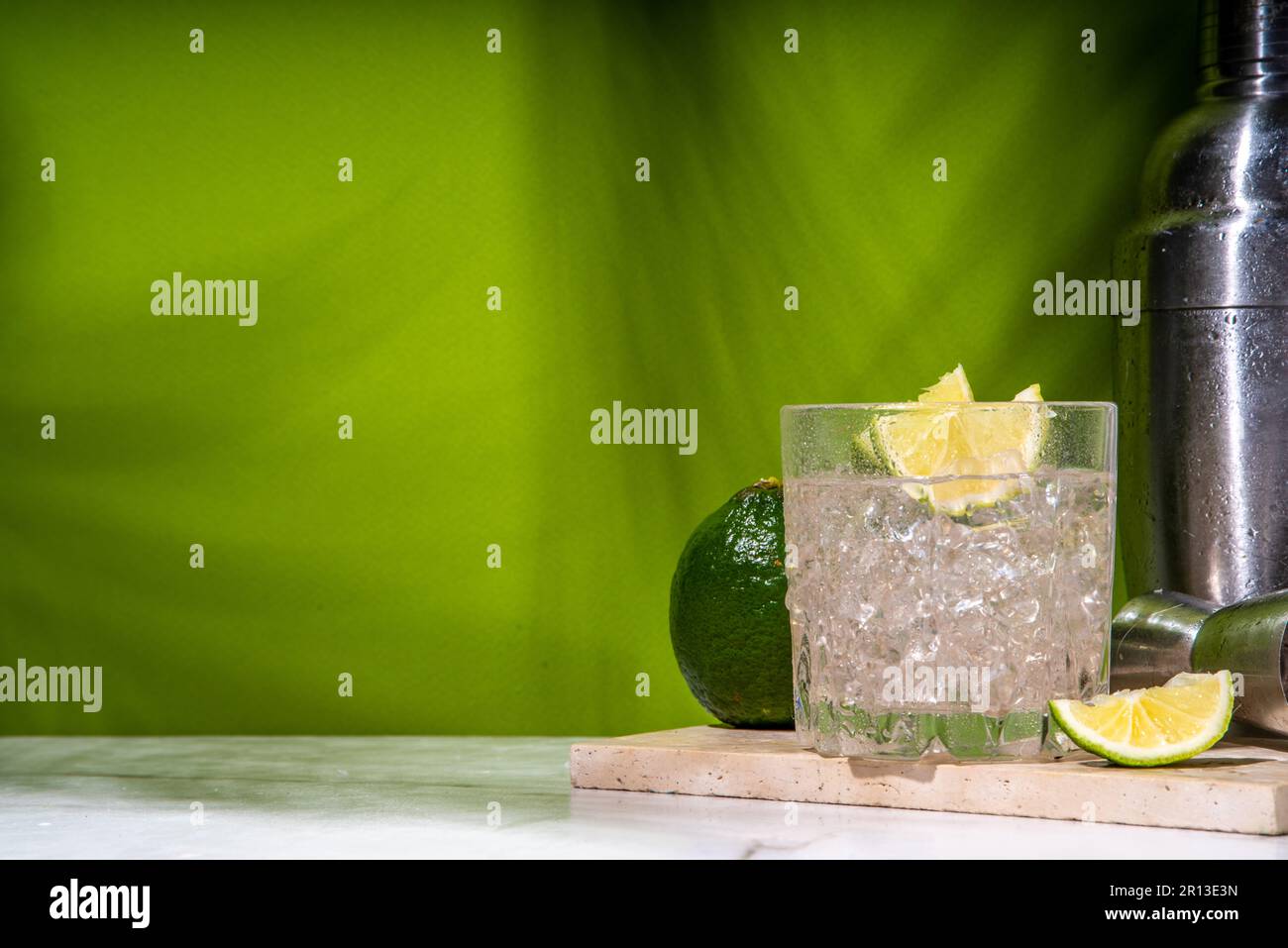 Cold iced Ti punch alcohol cocktail, small punch, rumbased mixed drink with fresh lime slice