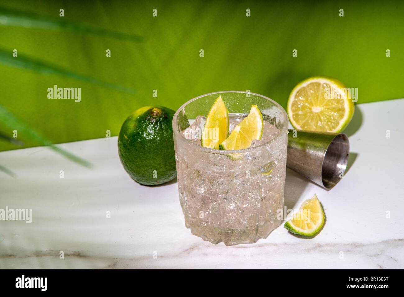 Cold iced Ti punch alcohol cocktail, small punch, rumbased mixed drink with fresh lime slice