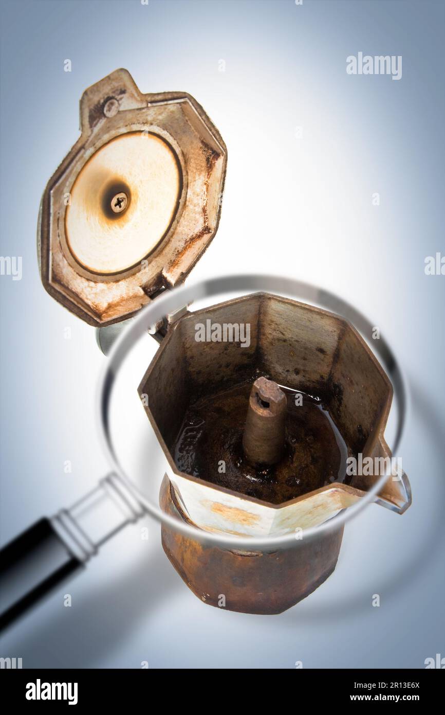 Old coffee maker (called moka or mocha) for italian coffee espresso  with open lid seen through a magnifying glass - Concept image Stock Photo -  Alamy