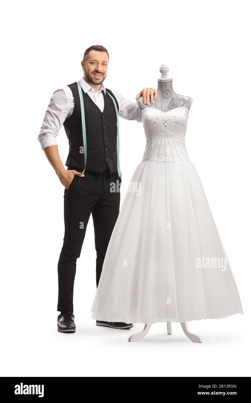Tailor standing next to a bridal gown on a doll mannequin isolated on white background Stock Photo