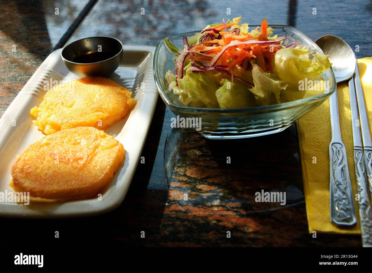 Traditional Korean appetizers. Fried soy bean galettes and salad. Selective focus Stock Photo