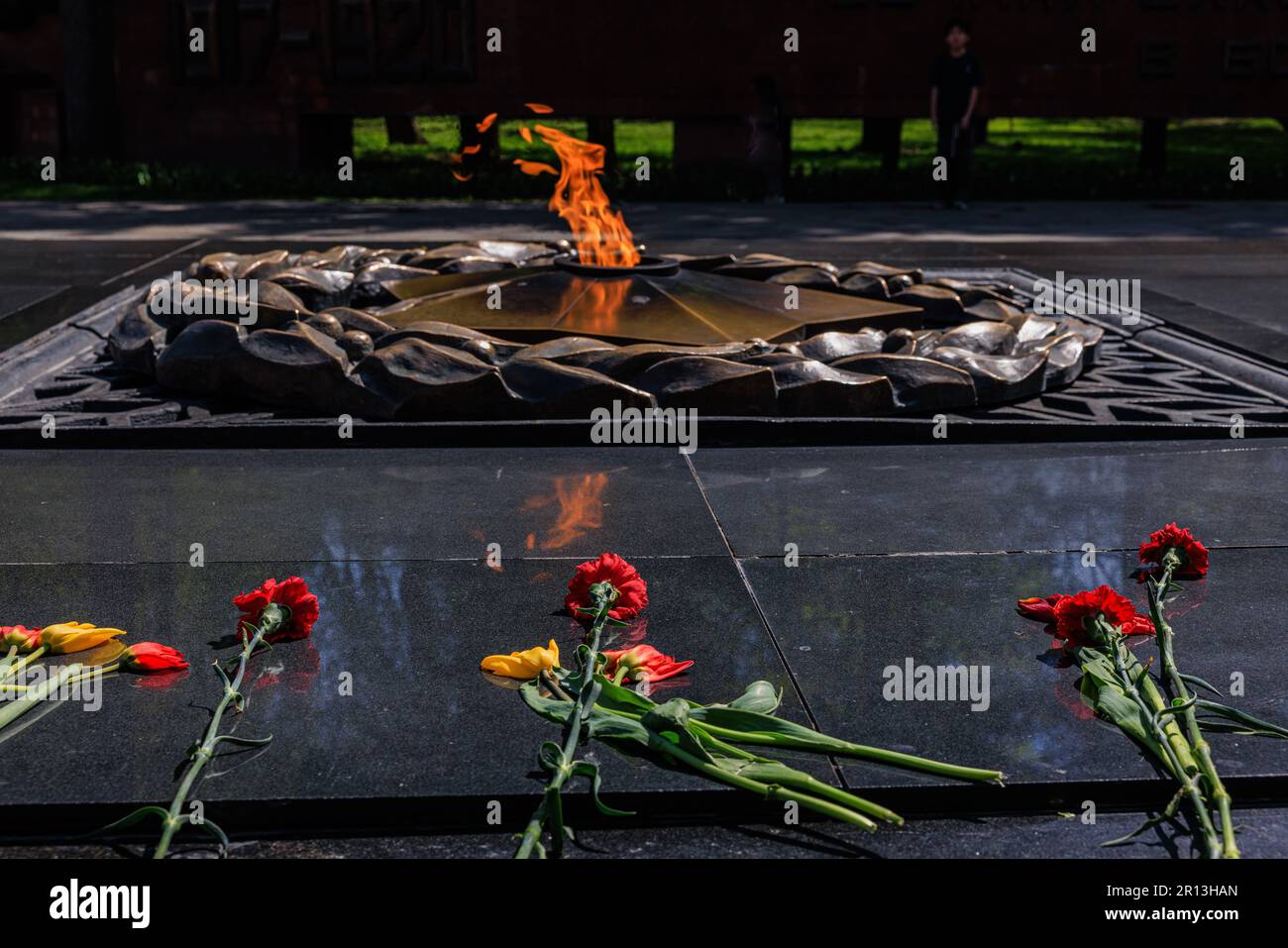 detail of the memorial of glory in Almaty of flowers laid in front of the eternal flame Stock Photo