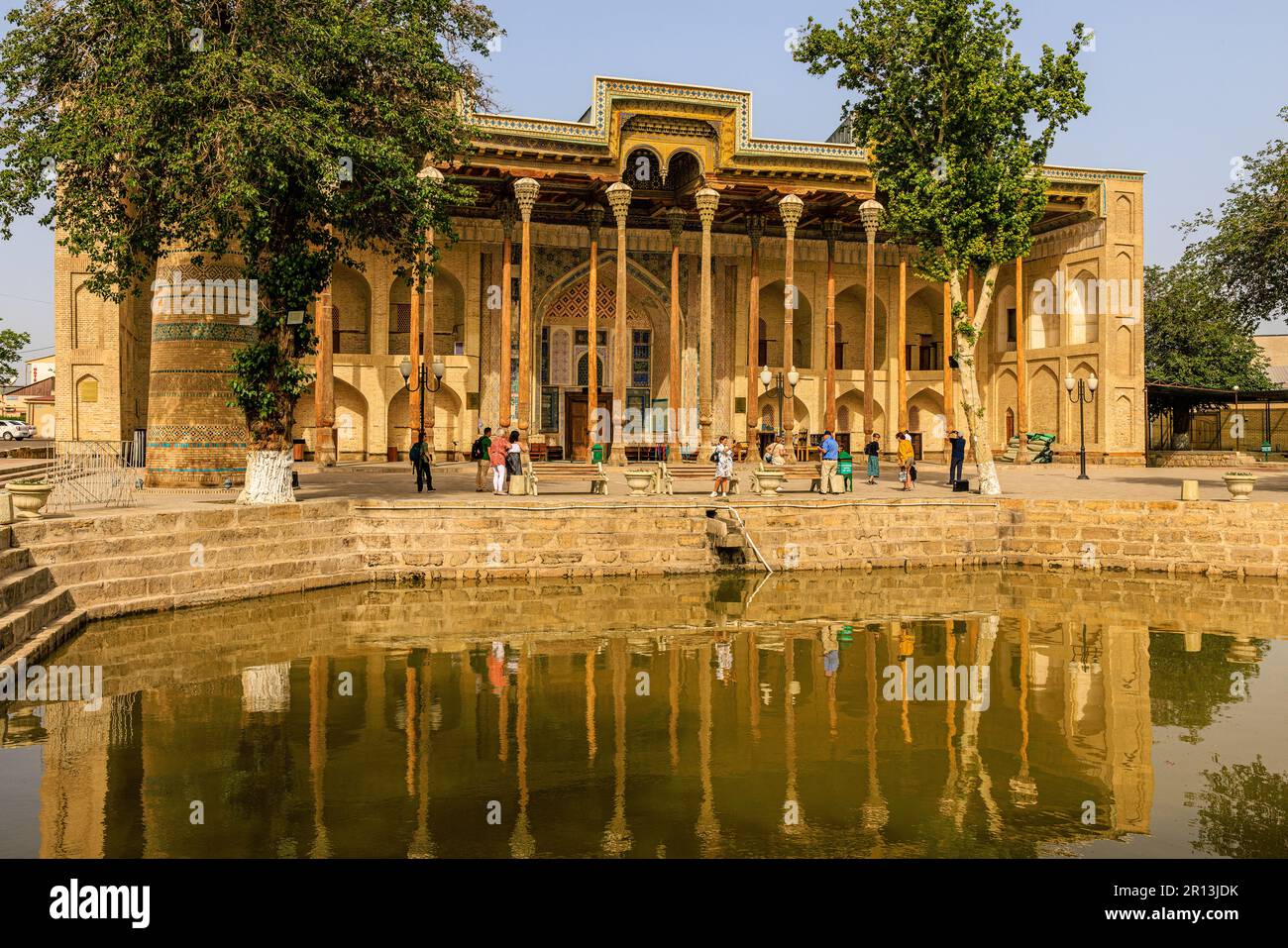 front facade of the bolo hauz mosque is reflected in the octagonal pool ...