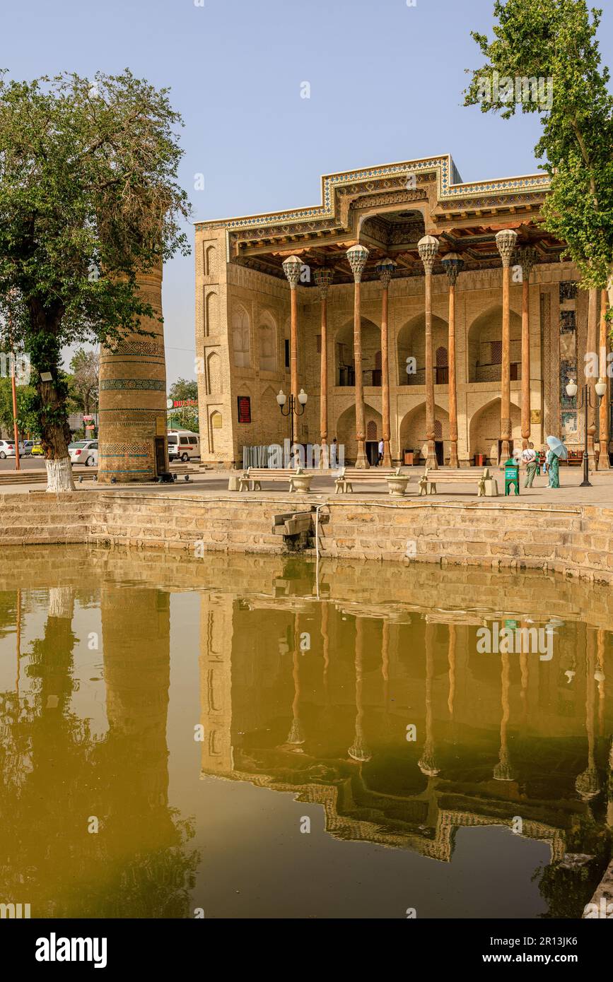 front facade of the bolo hauz mosque is reflected in the octagonal pool ...
