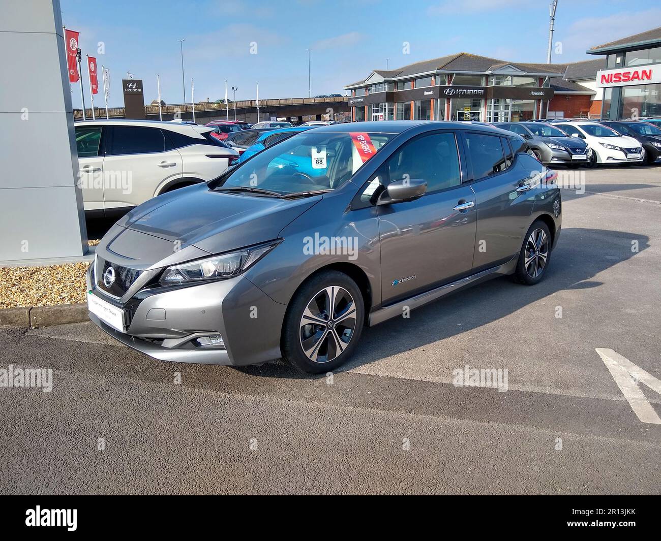 A used Nissan Leaf Electric Vehicle on a Nissan dealership forecourt in
